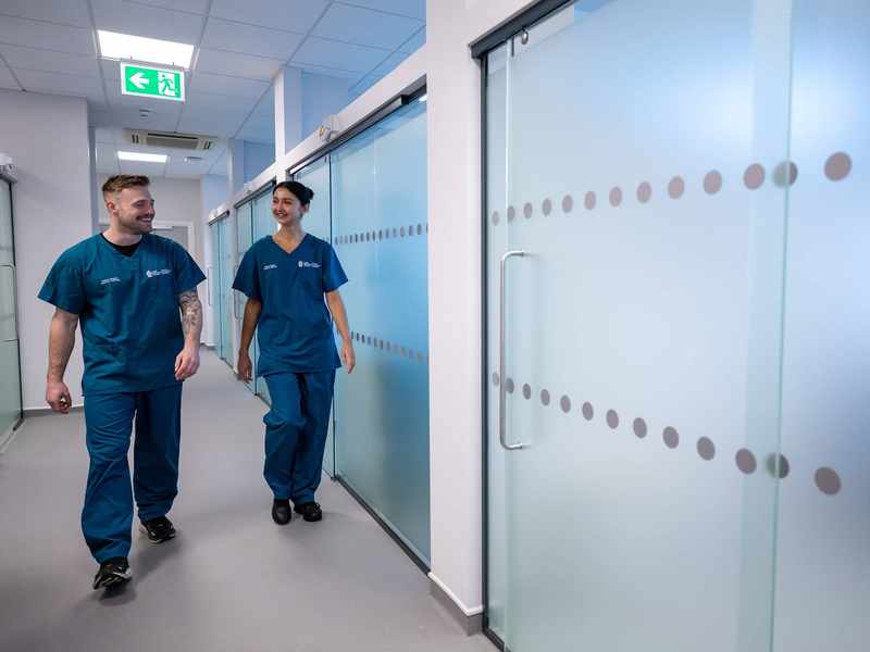 Two students walking through Allied Clinical Health Hub