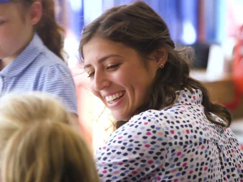 Teacher smiles at pupil
