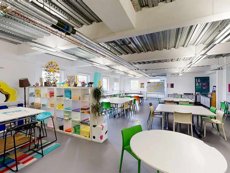 Collection of tables and chairs alongside a bookcase