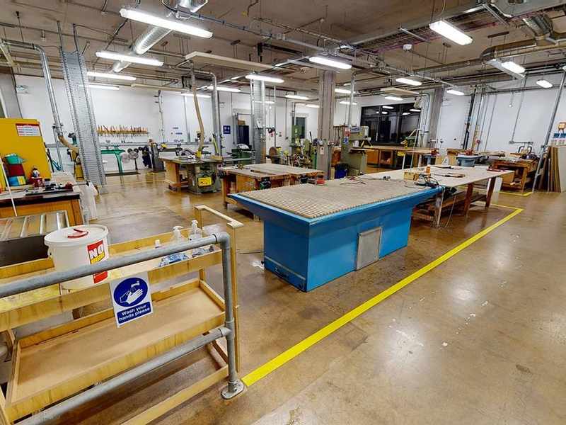 Wide view of workshop floor including tables and safety equipment