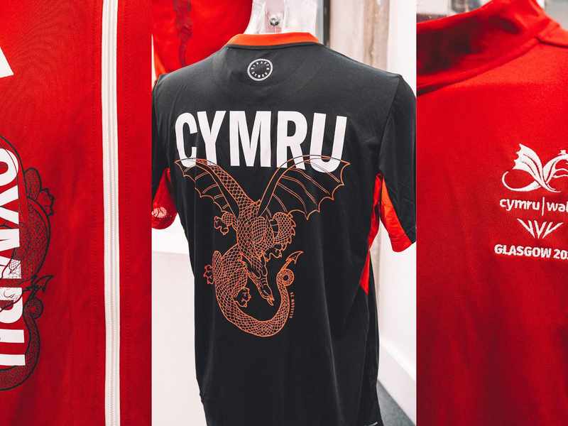 Wales Commonwealth team kit featuring a red jersey with white accents and the Welsh dragon emblem on the chest.