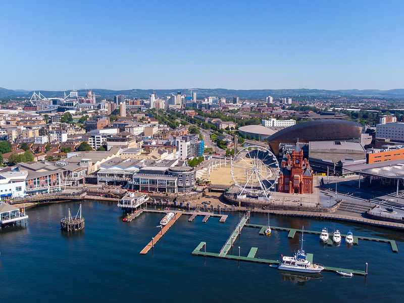 Aerial view of Cardiff city centre with the River Wye flowing through, showcasing urban architecture and green spaces.
