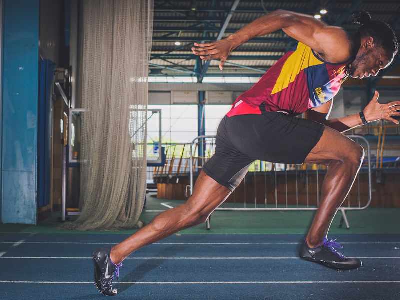 Side view of sprinter running on a track