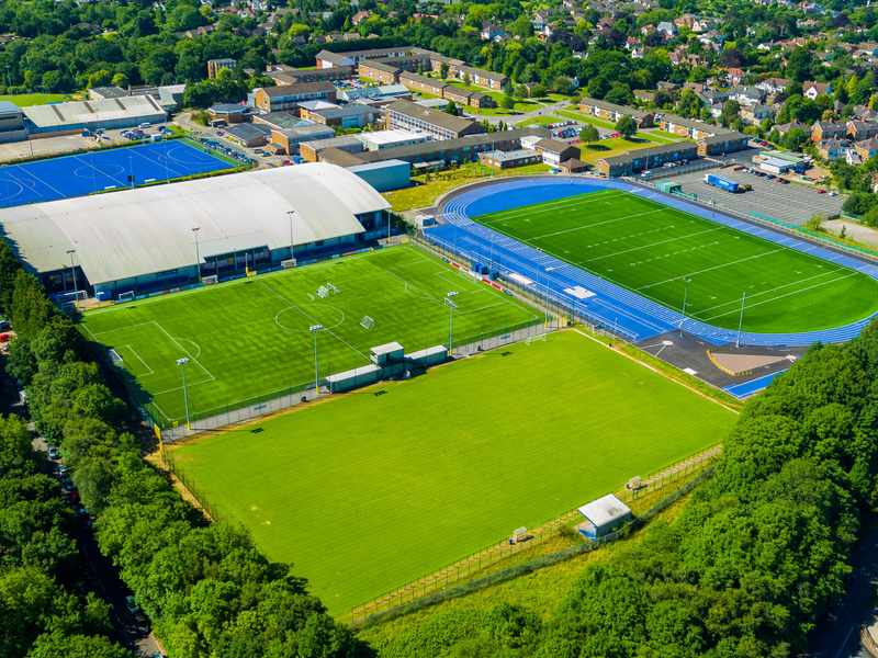 Aerial view of the Cyncoed Campus, featuring several sports pitches and a running track