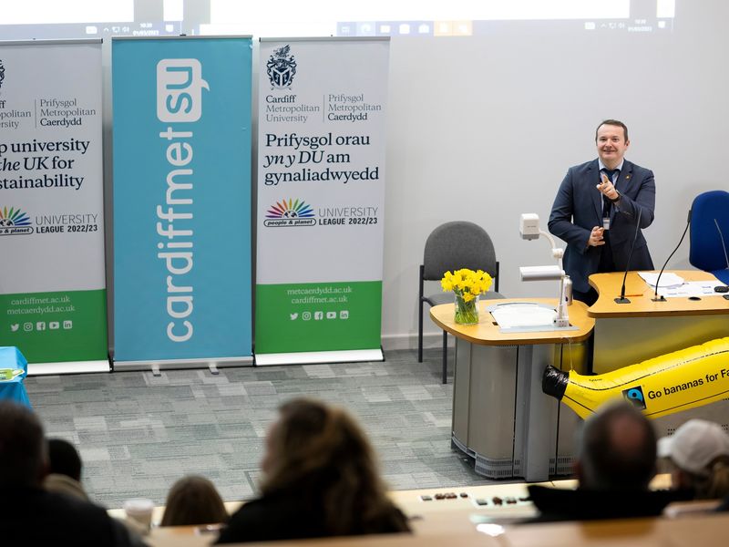 A member of Cardiff Met staff hosts a sustainability meeting in a lecture hall