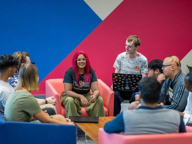Cardiff School of Technologies students sat around a coffee table in discussion