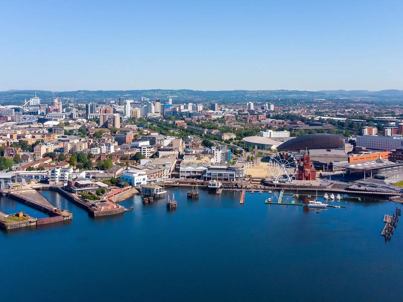 Aerial view of Mermaid Quay in Cardiff Bay, with the city of Cardiff in the background.