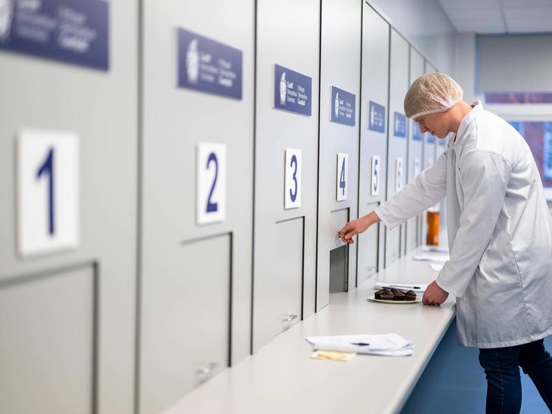 Student opening sliding panel in Food Industry Centre evaluation suite