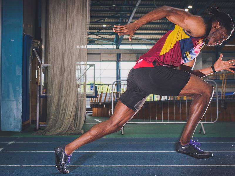 Side view of sprinter running on a track