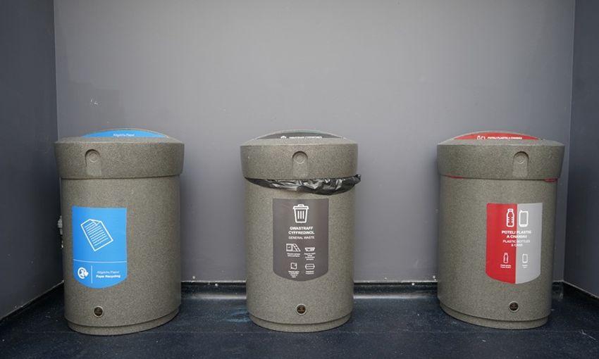 Three colour-coded waste and recycling bins