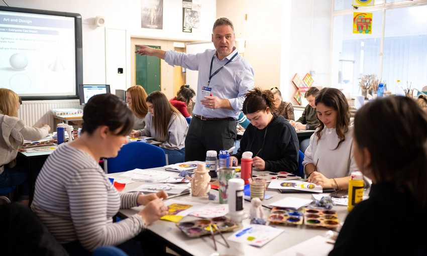 Lecturer with student teachers in art and design class