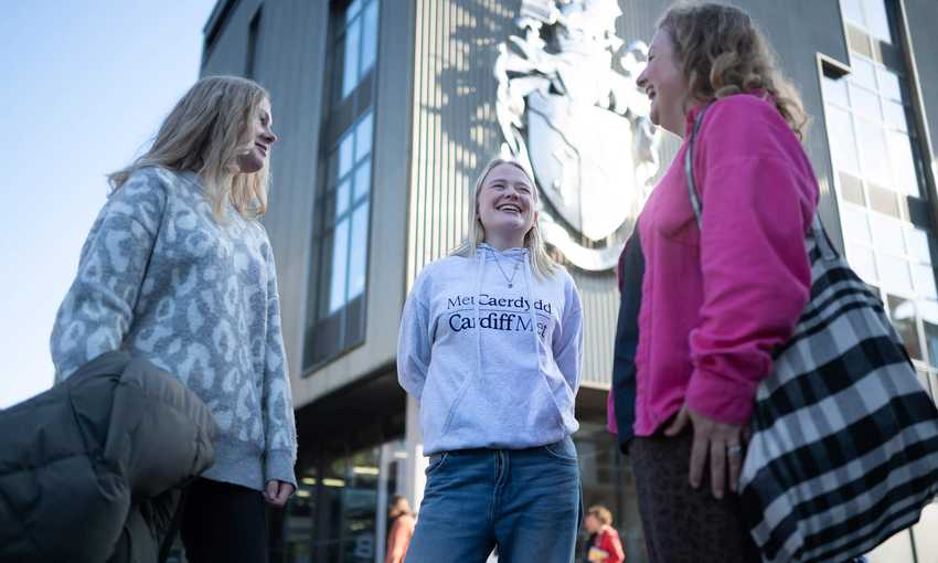 A Student Ambassador with two Open Day visitors.