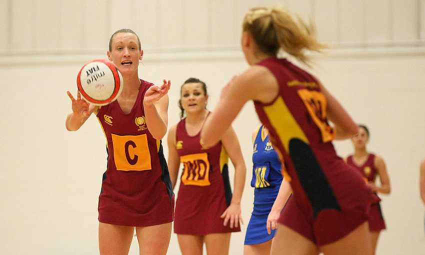 A Cardiff Metropolitan University netball player throws the ball to a teammate during a game