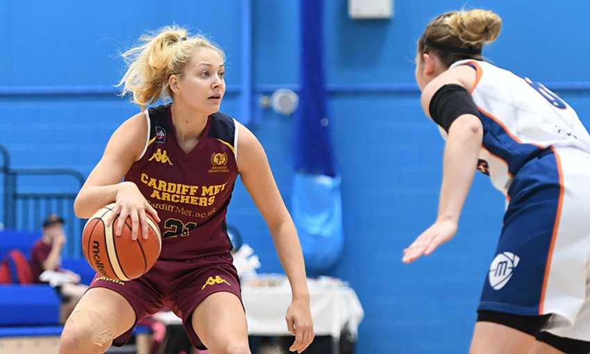 Cardiff Met Archers student player dribbles with a basketball against an opponent