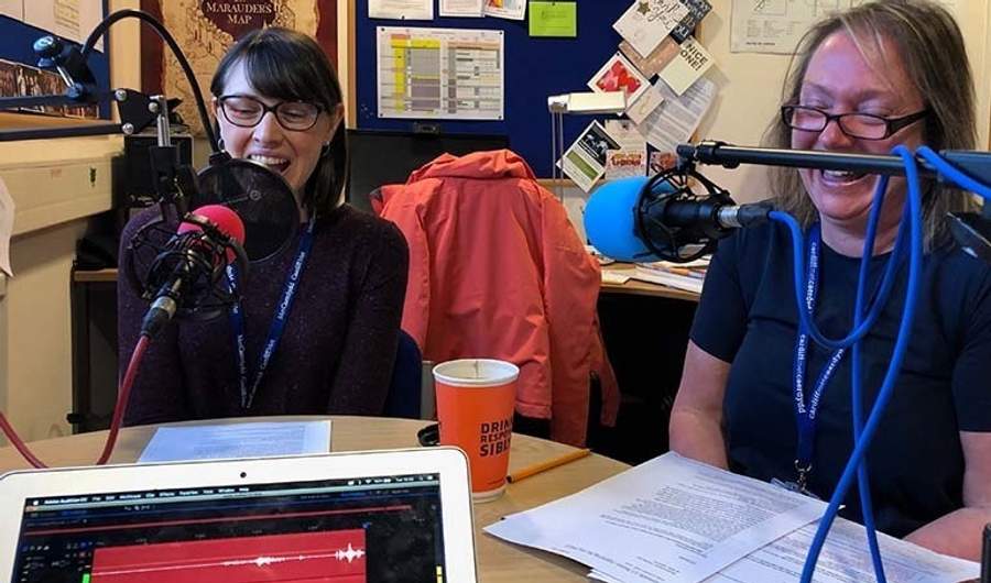 Lecturers sat in front of microphones at a round table in discussion