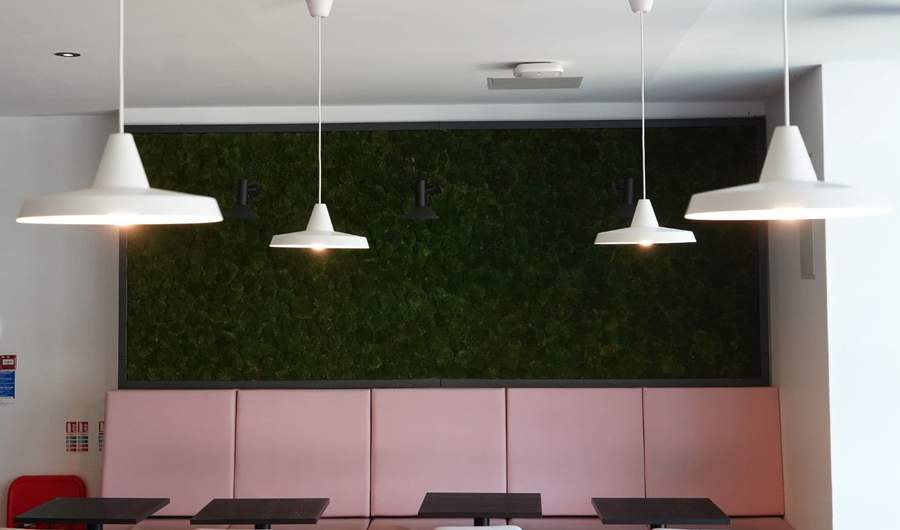 A collection of hanging lights above common area seating on Cardiff Met campus