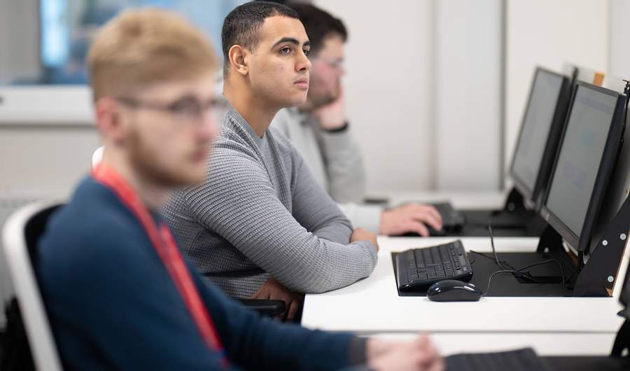 Group of students using computer workstations