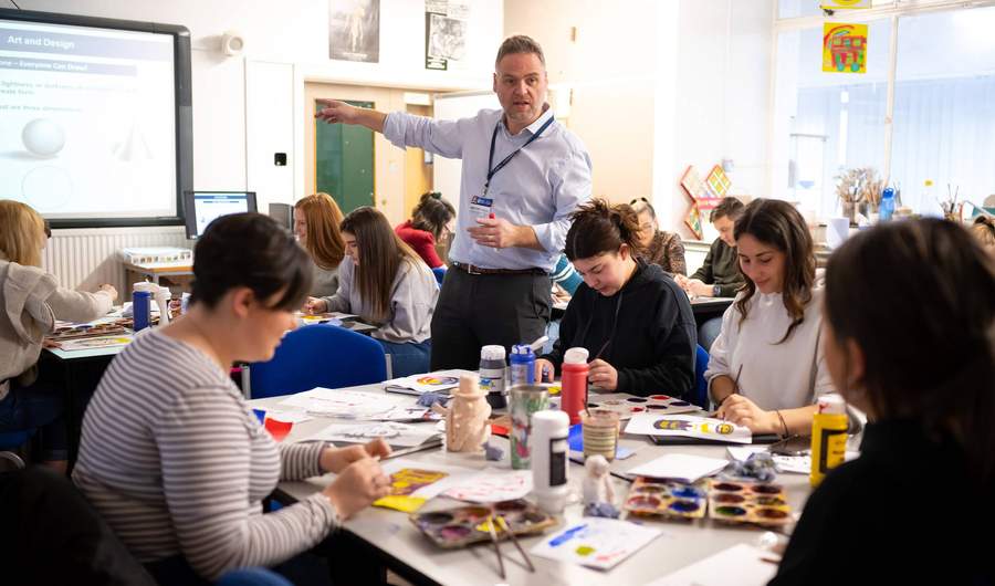 Lecturer with student teachers in art and design class
