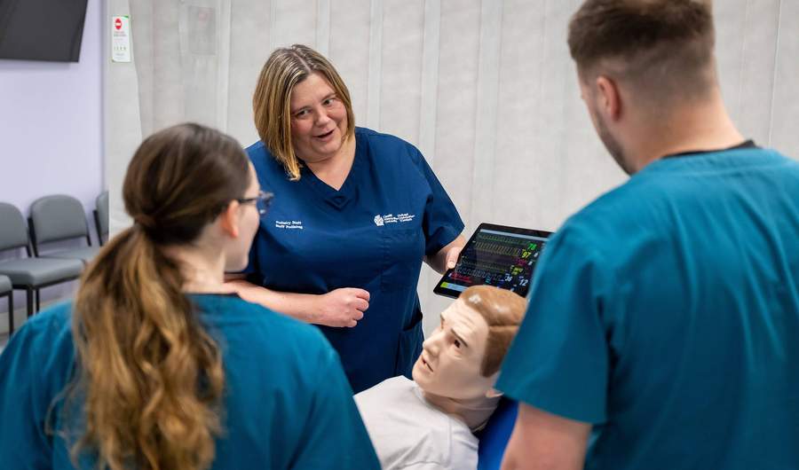Lecturer and students with manikin in Allied Clinical Health Hub