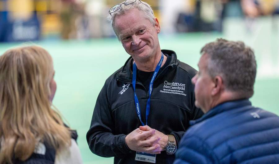 A lecturer speaking to visitors at an Open Day Information Fair.