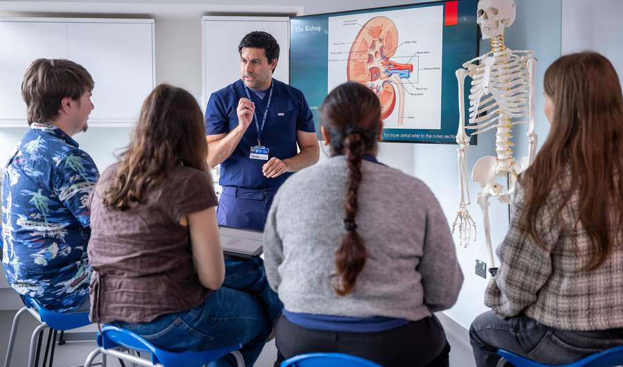 Nursing lecturer with group of students