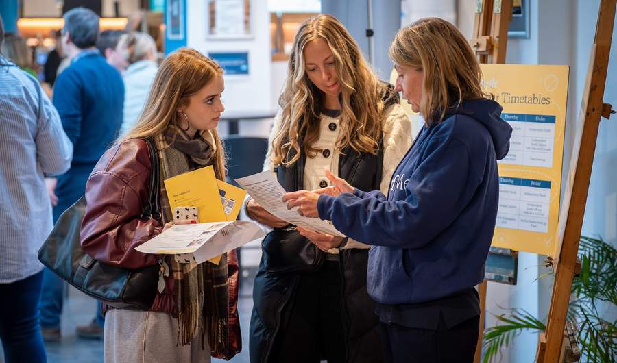 Cardiff Met staff with visitors at an Open Day Information Fair.