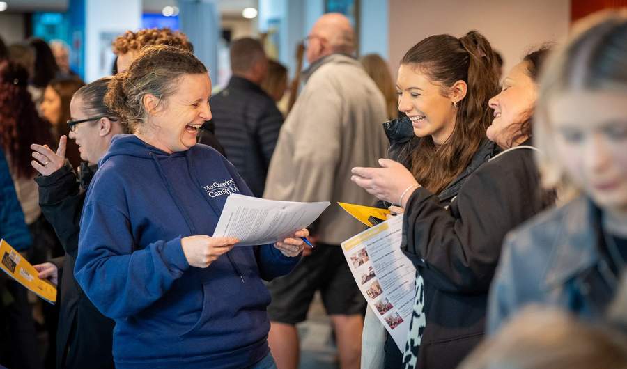 Cardiff Met staff with visitors at an Open Day Information Fair.