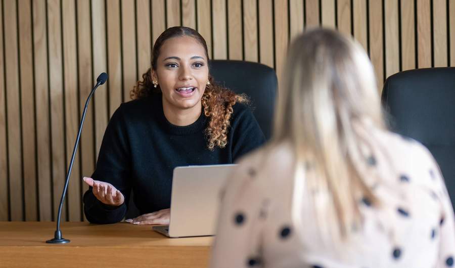 Student sitting at bench in Moot Courtroom