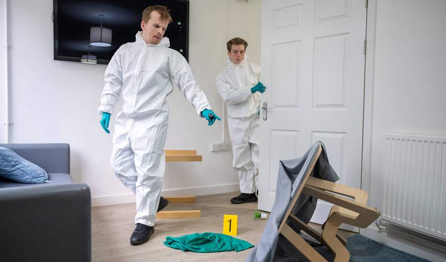 Students entering simulated crime scene in Crime House