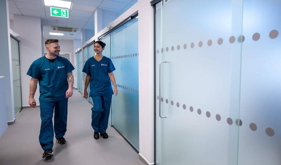 Two students walking through Allied Clinical Health Hub