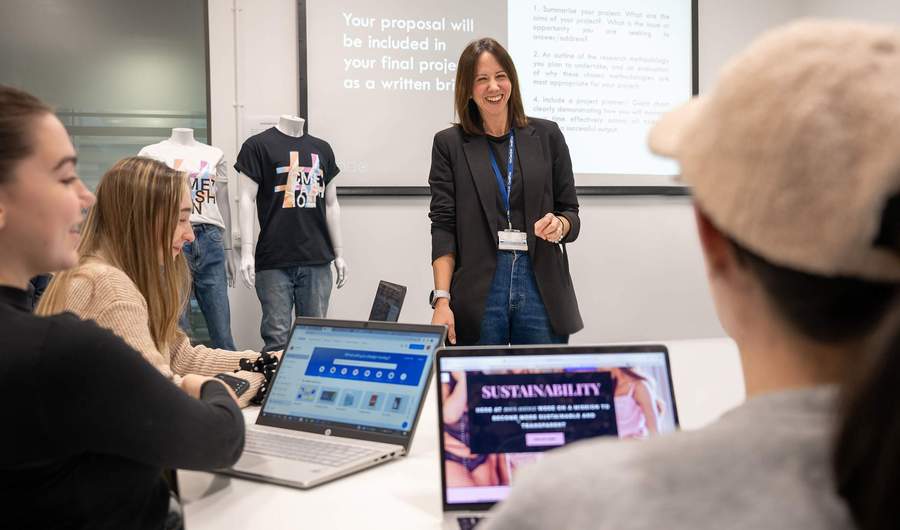 A person stands in front of a class of students.