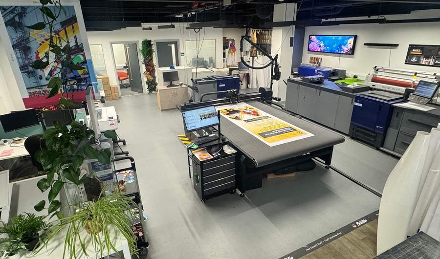 A view from the corner of the Print Studio, featuring various printing machines and workbenches