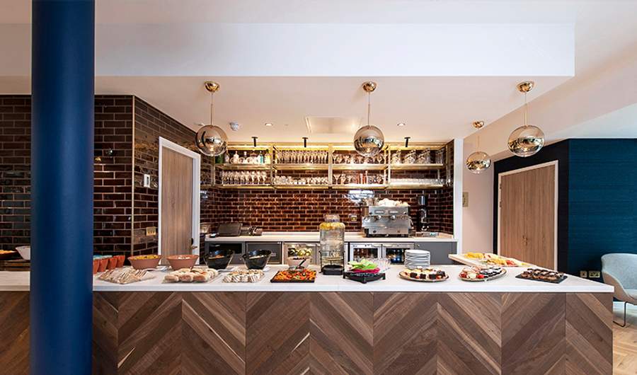 A spread of fresh food on display in front of a drinks bar