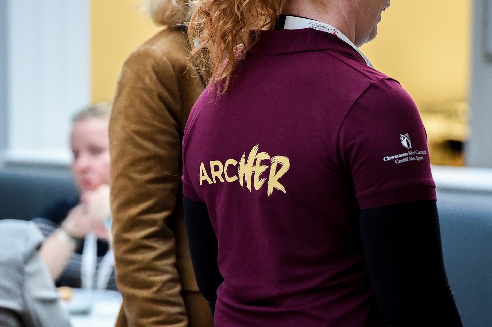 ArcHER logo on the back of an attendees' t-shirt