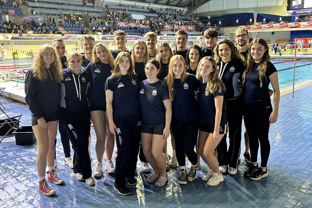 The Cardiff Met Swim Club poses for a photograph by the International Sports Centre swimming pool