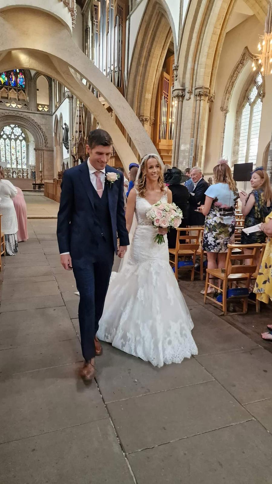 Ceris and Mark Palser walk down the Llandaff Cathedral aisle on their wedding day