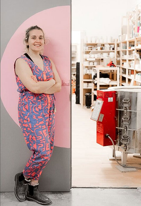 Charlotte Manser stands outside her ceramics workshop