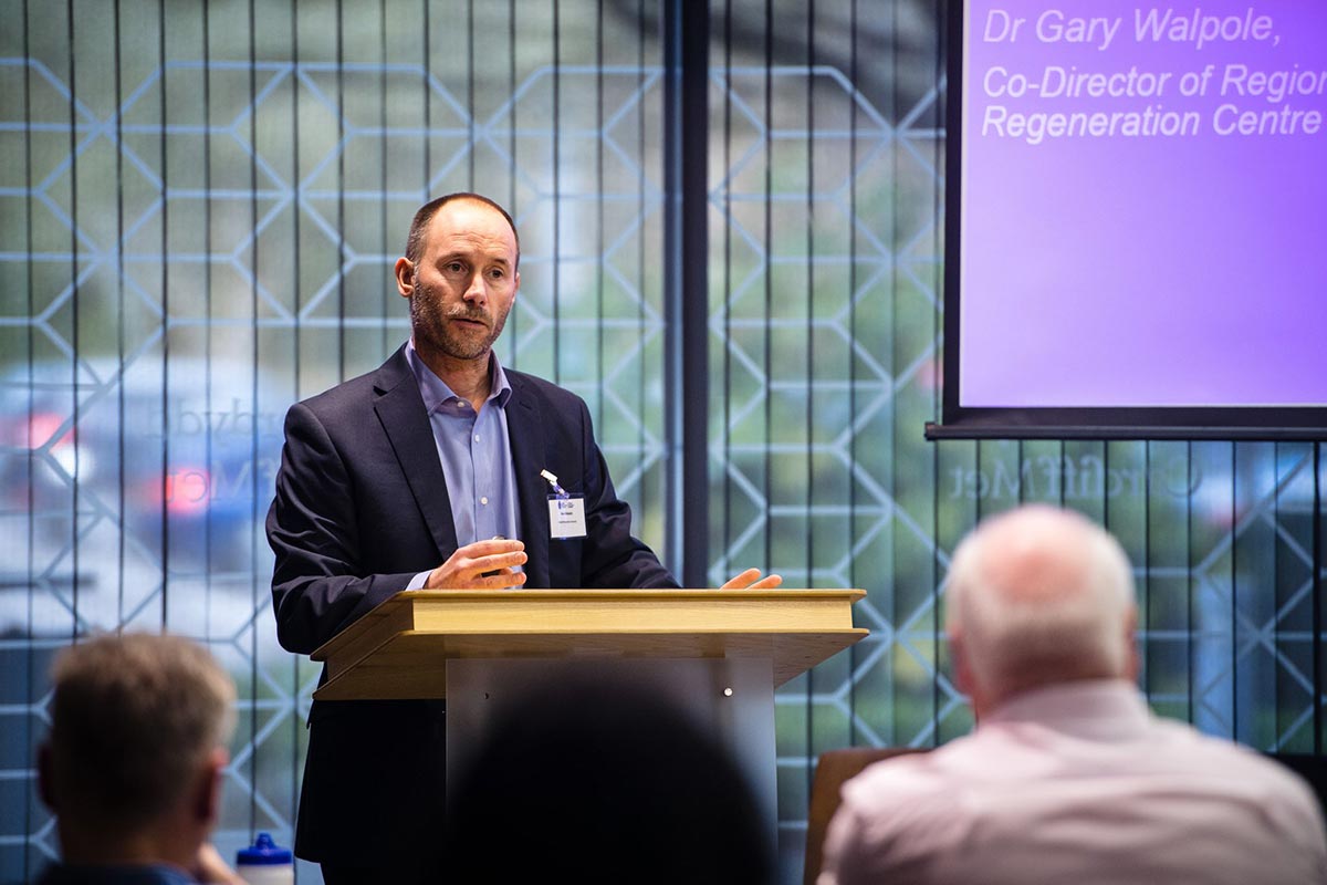 Dr Gary Walpole presenting from behind a podium