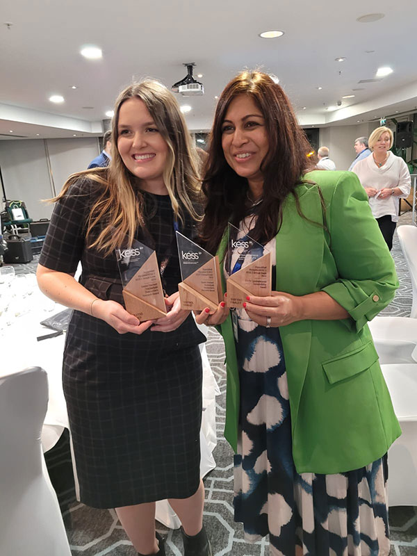 Lauren Jones, left, has photograph taken with award