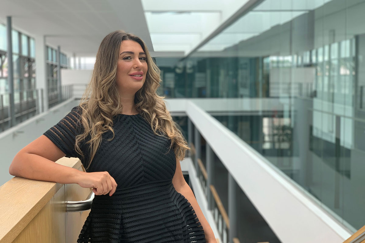 Lauren Reilly stands for a photograph in the Cardiff School of Management building