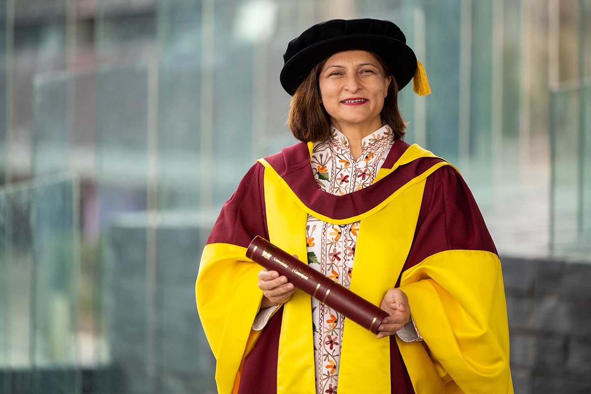 Dr Nishat Riaz holding her Honorary Doctorate