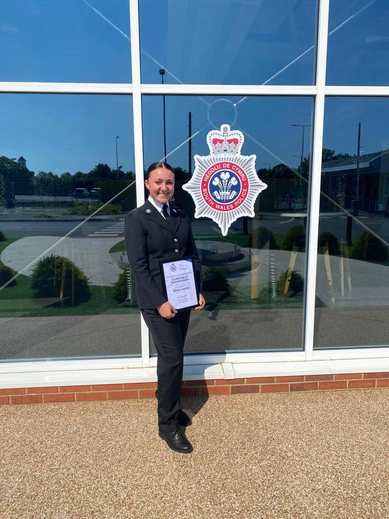 Olivia Lester holding a Certificate of Commendation from South Wales Police