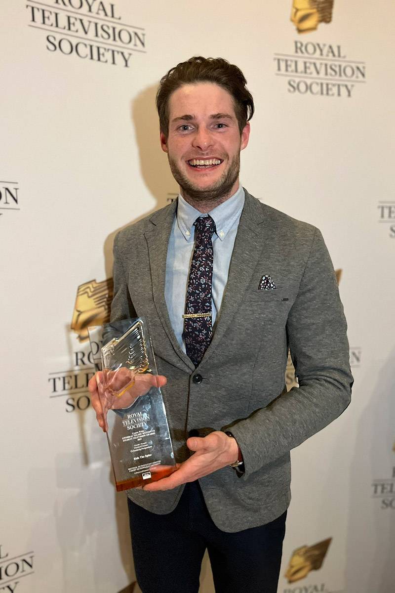 Chris Knight holding an award for the best Student Postgraduate award for his documentary, awarded by the Royal Television Society Cymru