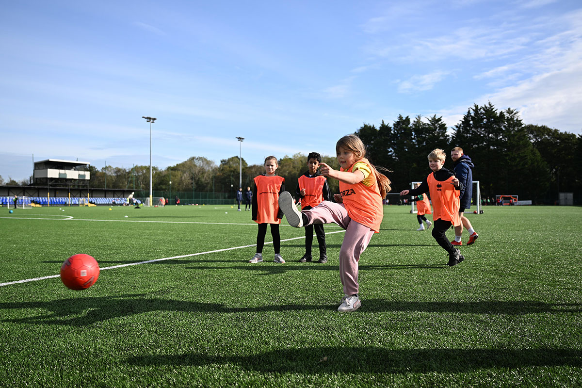 School children play football during a Cardiff Met Open Campus event