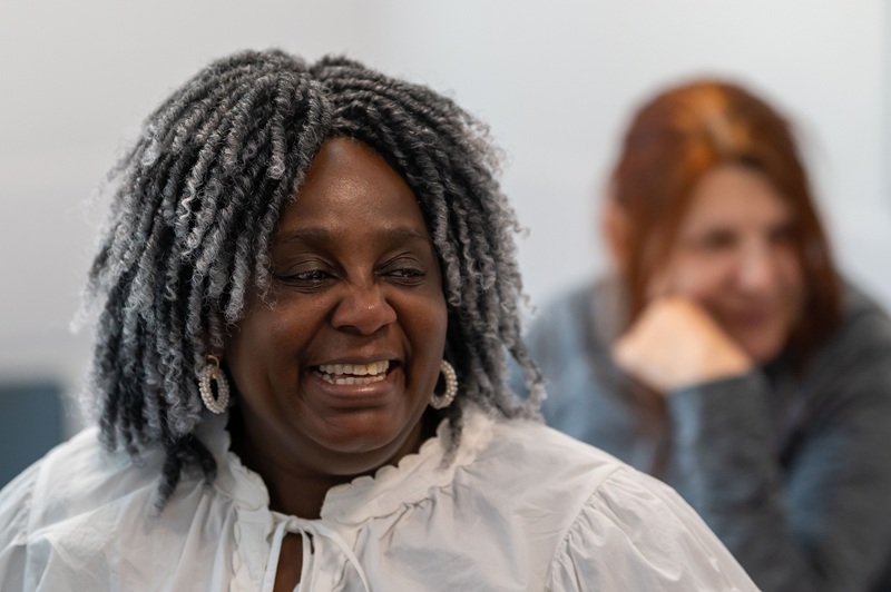 An adult learner laughs during a lesson