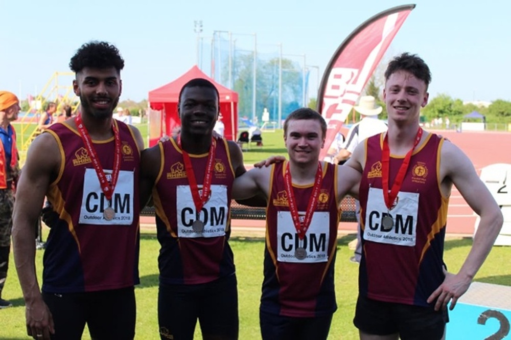 Four Cardiff Met athletes wearing medals