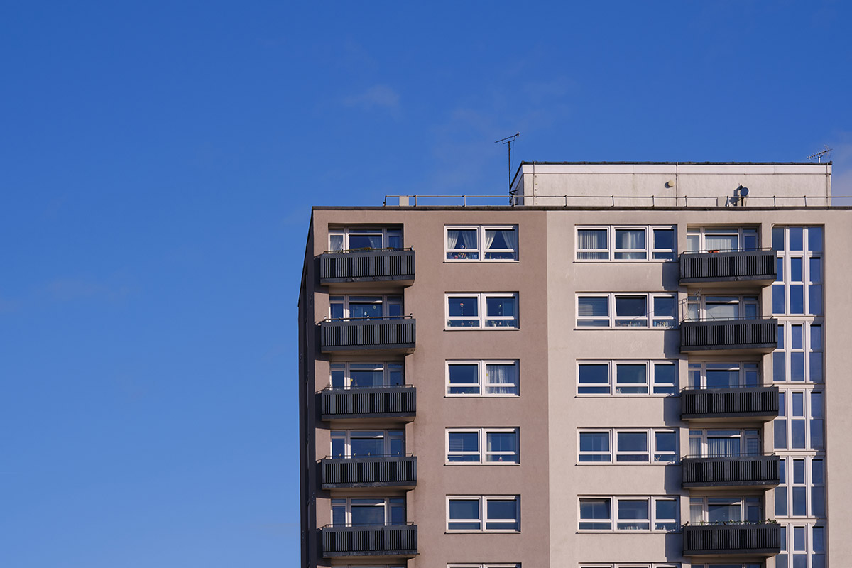 A tall building set against a clear blue sky.