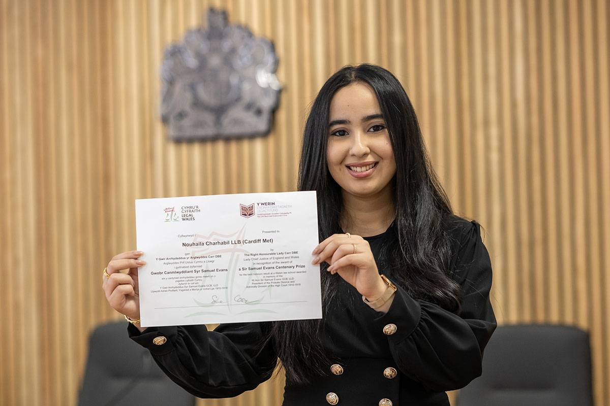 Nouhaila Charhabil photographed with certificate of the Sir Samuel Evans Award