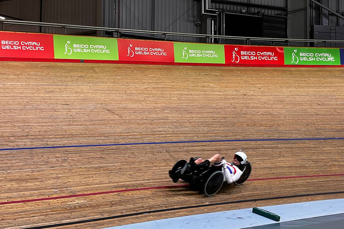 Paralympic cyclist practising their sport on a curved cycling track