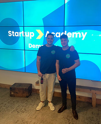 Harris Cole and Louis Cochrane in front of the Startup Academy sign